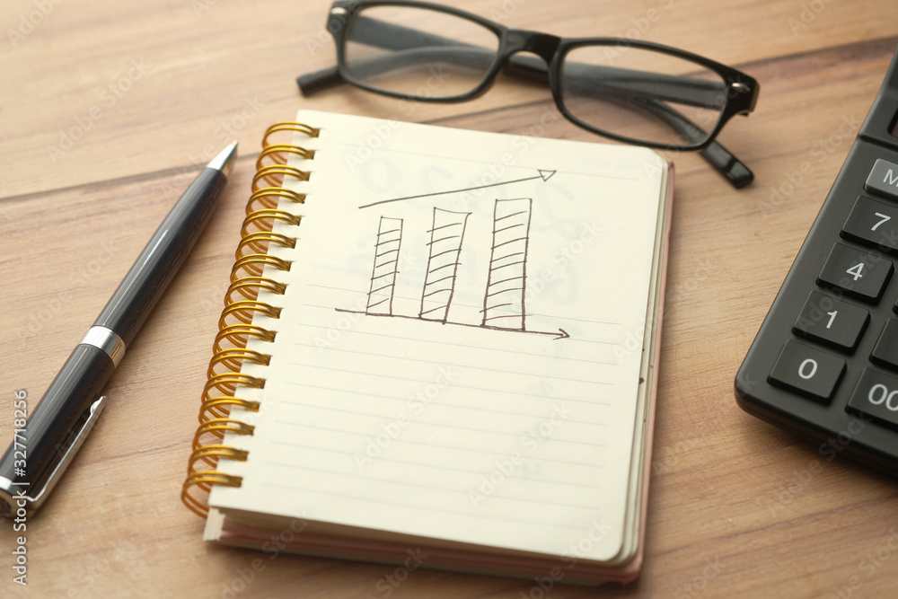 growth chart on notepad with pen on table growth chart on notepad with pen on table