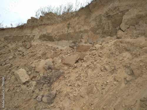 sprinkled on the loose soil clay soil with stones in the excavated pit