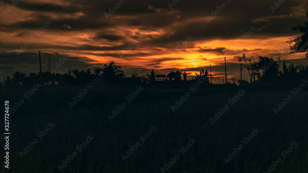 Sunset from Rice Field with Balinese Temple in SIlhouette