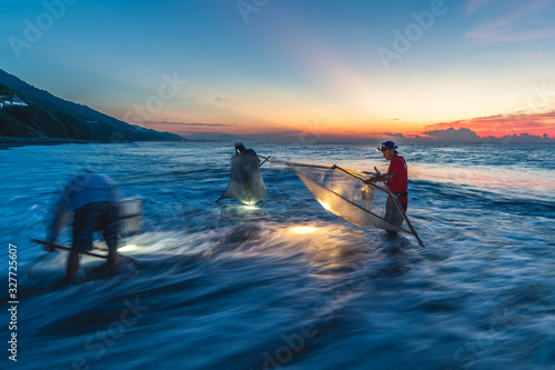 Taitung, Taiwan - July 31, 2016: traditional method to catch fish with triangle fishing net at the mouth of  jinlun river, taitung, taiwan.