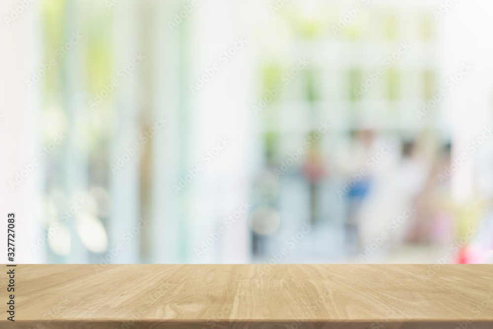 Empty wood table top and blurred of interior restaurant with window view green from tree garden background background - can used for display or montage your products.