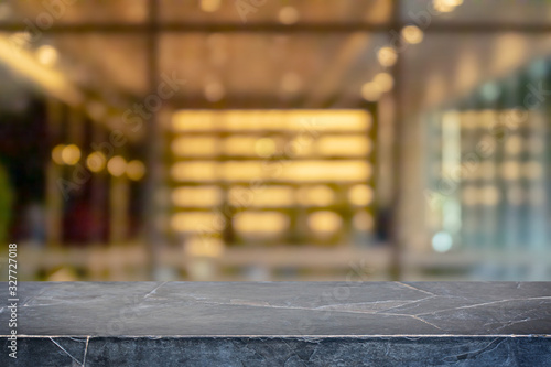Empty black marble stone table top and blur glass window interior restaurant banner mock up abstract background - can used for display or montage your products.