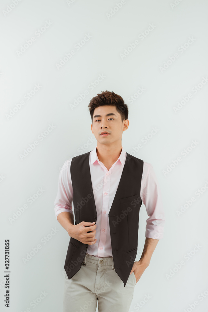Handsome young Asian man standing over white background Handsome young Asian man standing over white background