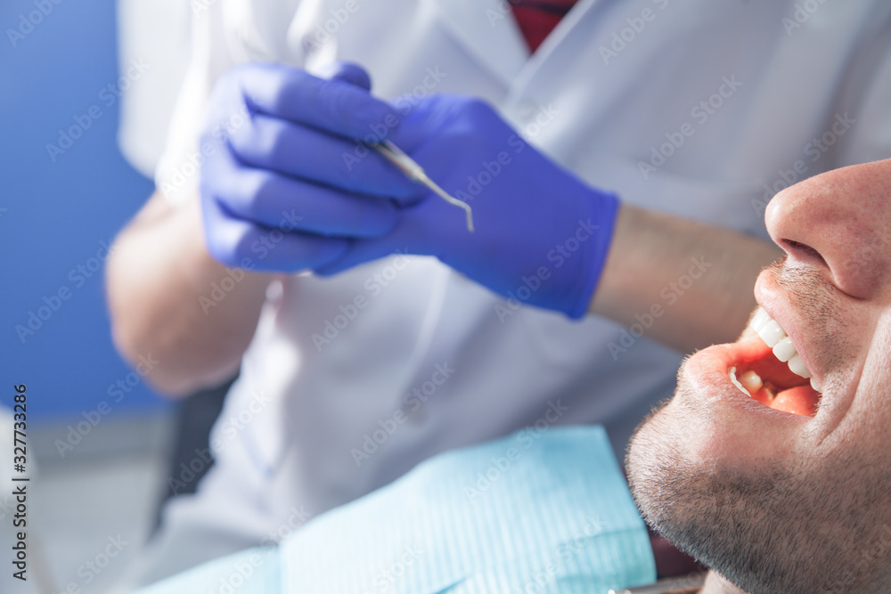 Man sitting in a dental chair in the clinic. Man sitting in a dental chair in the clinic.
