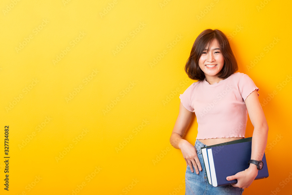 Beautiful asian woman University student happy on yellow background Beautiful asian woman University student happy on yellow background