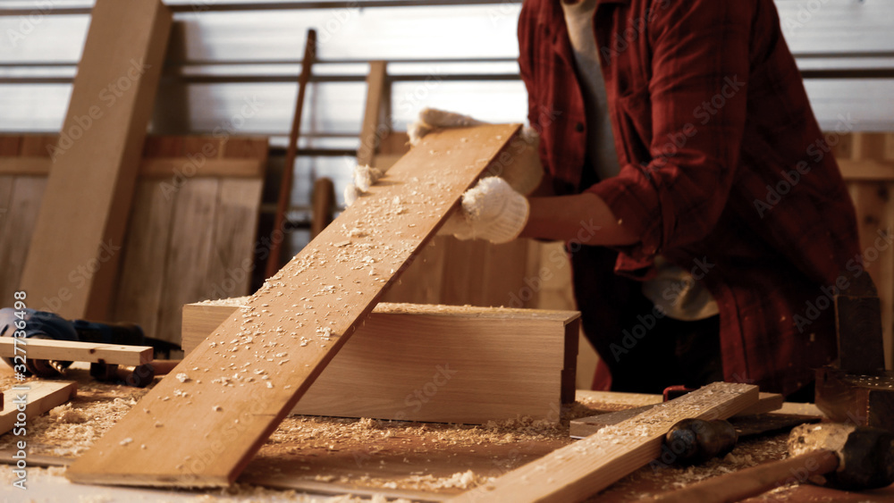 Carpenter holding pieces of board at site. Carpenter holding pieces of board at site.