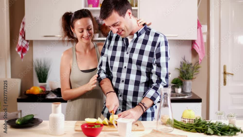 Young couple in love cooking together Young couple in love cooking together