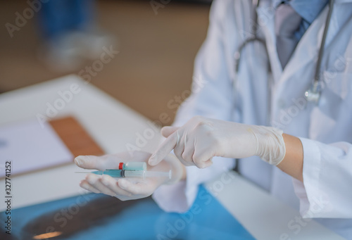 Medical syringe in the hand, palm or fingers Vaccination equipment with plastic needles Nurse or doctor Liquid drugs or drugs Health care in hospitals
