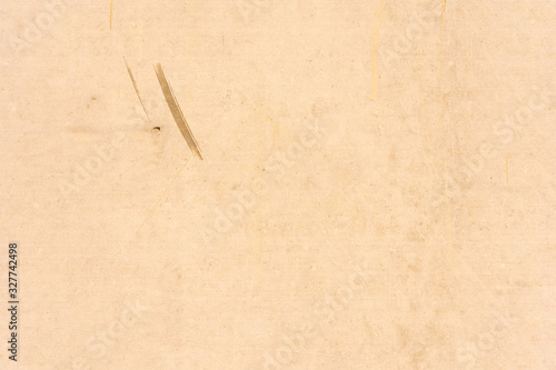 Surface of yellow brown color stucco wall with scratch and stain background. Yellow brown painted cement wall texture