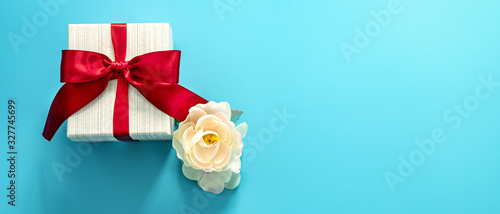  gift box with red bow on a blue background . Happy Father's or Mother's or Women 's  day celebration concept