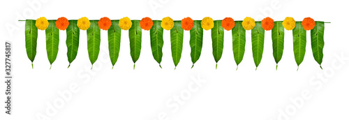Indian flower garland of mango leaves and marigold flowers. Ugadi diwali ganesha festival poojas weddings functions holiday ornate decoration. Isolated on white background natural mango leaf garland photo