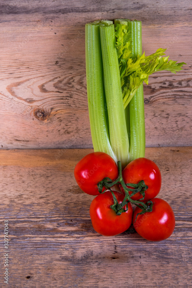 celery, sprig of tomato on a wooden board celery, sprig of tomato on a wooden board