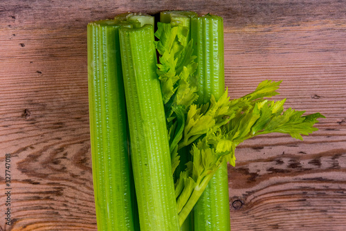Celery on a wooden background, close-up, space for text