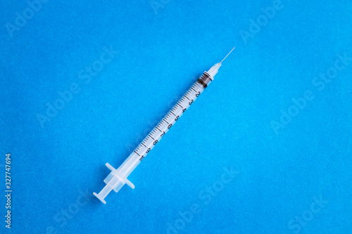 Syringes on blue background. Medicine and pharmacology. Injection, vaccination, immunization. Positive attitude to medicine and doctors. Insulin syringe. Diabetes.