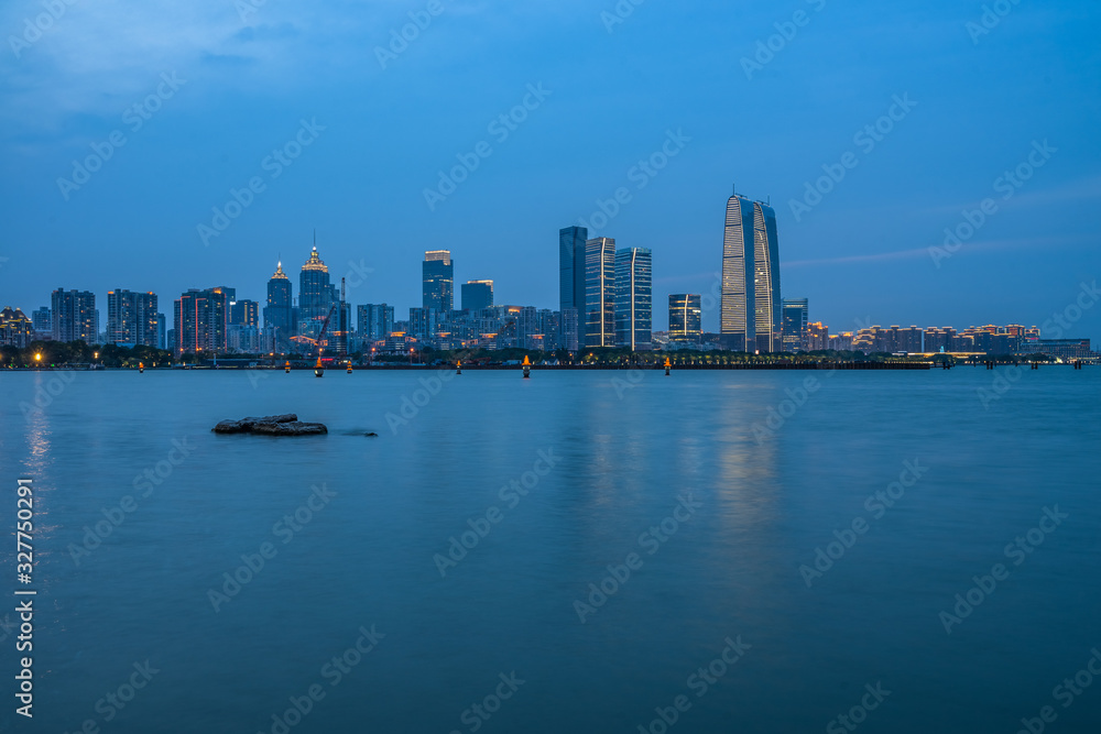 Beautiful city skyline and tranquil lake in Suzhou at twilight