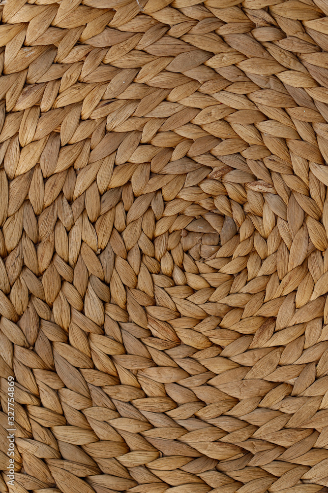 Abstract weave background .Close-up of a surface of interwoven threads in a circle. Natural brown textured background. Vertical, close-up, free space, cropped shot. Design concept.