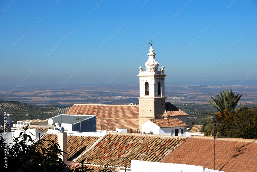 San Sebastian parish church (Iglesia Parroquial de San Sebastian) with view over rooftops towards countryside, Estepa, Spain.