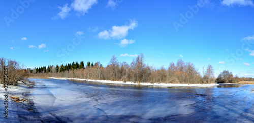 Panorama with a mirror reflection of the forest in the river