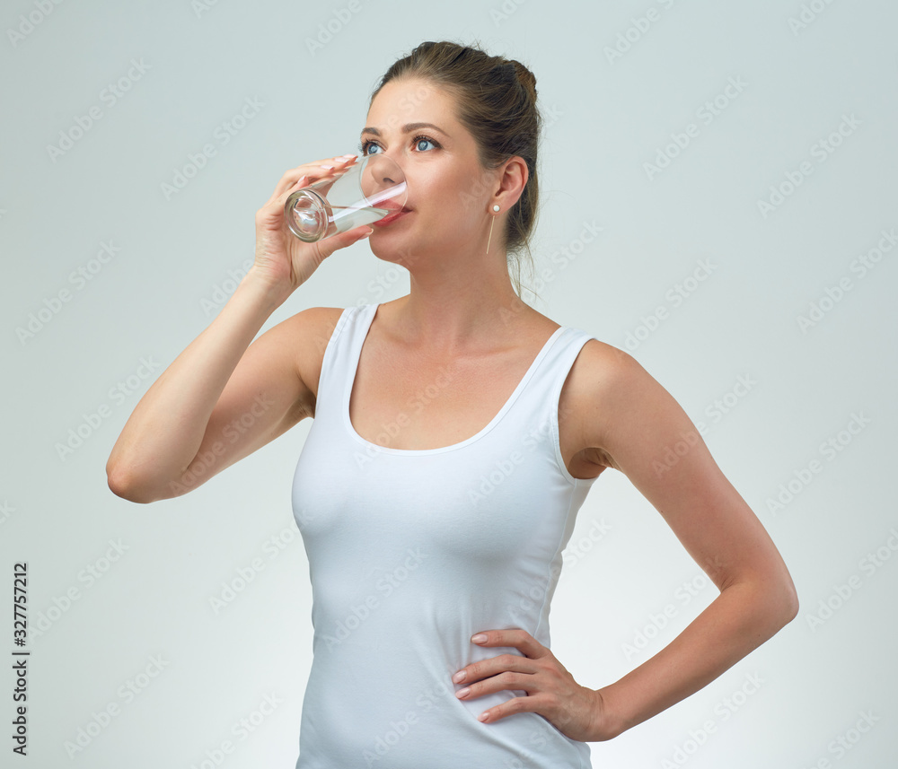 Sporty woman drinking water from glass. Sporty woman drinking water from glass.