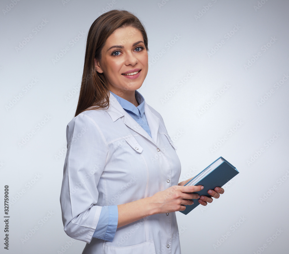 smiling woman doctor in white uniform holding books. smiling woman doctor in white uniform holding books.
