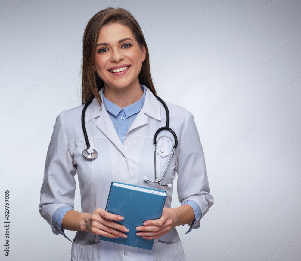 Young woman doctor with big toothy smile holding book Young woman doctor with big toothy smile holding book