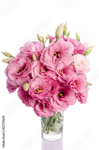 bunch of white and pink eustoma flowers in glass vase isolated on white