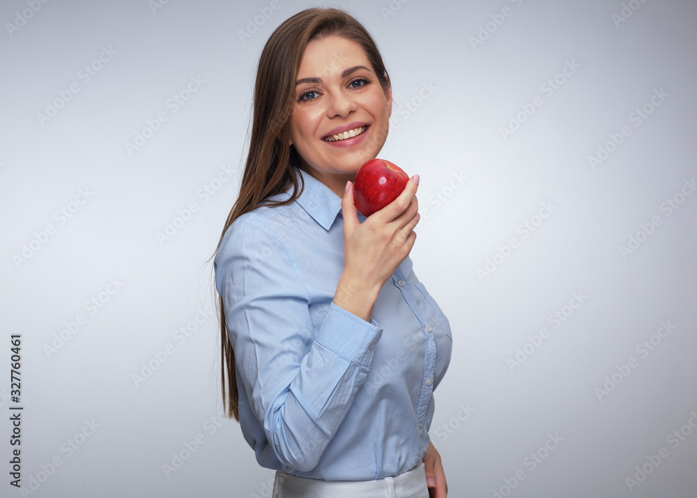 Smiling woman in blue shirt holding red apple. Smiling woman in blue shirt holding red apple.