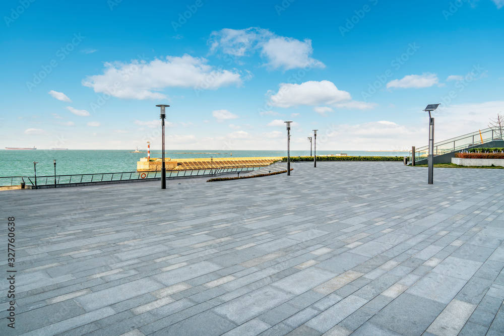 Floor tiles and seascape of city square..