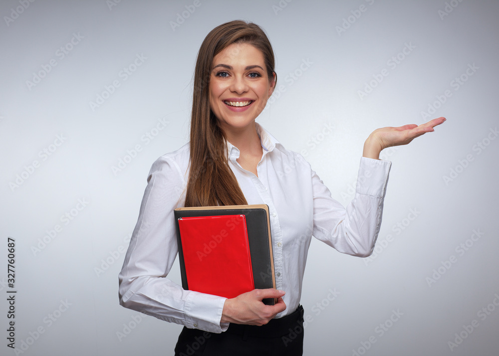 Happy teacher or businesswoman holding book and empty gesture hand. Happy teacher or businesswoman holding book and empty gesture hand.
