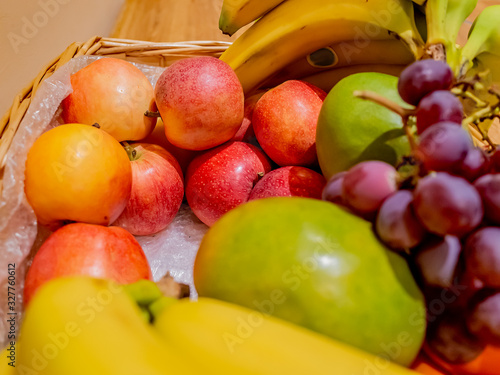 Selective focus on apples in a wicker basket full of fresh and healthy fruit