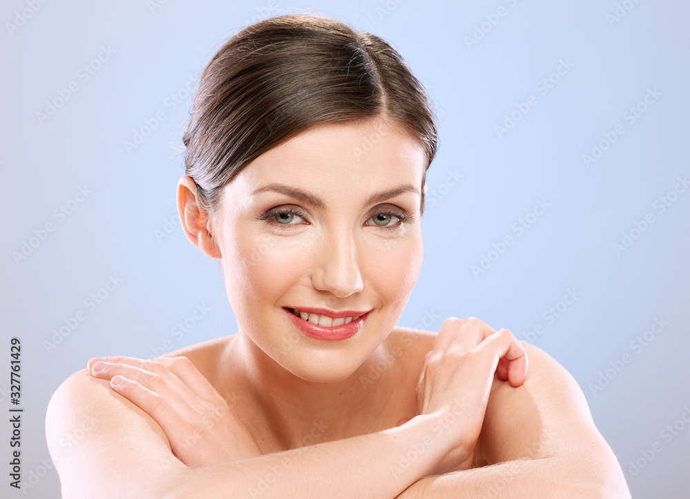 young woman with naked shoulders sitting at white table. young woman with naked shoulders sitting at white table.