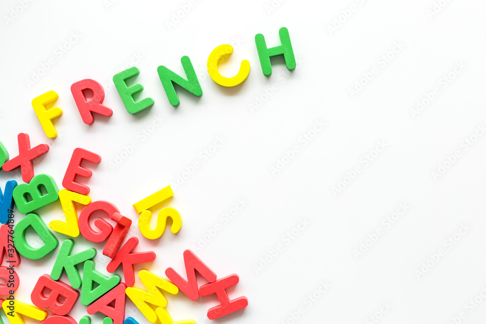 Learn French. Concept with letters on white background top-down copy space Learn French. Concept with letters on white background top-down copy space