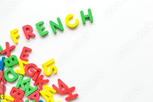 Learn French. Concept with letters on white background top-down copy space