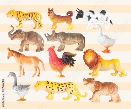 Group of plastic animal doll isolated on color background