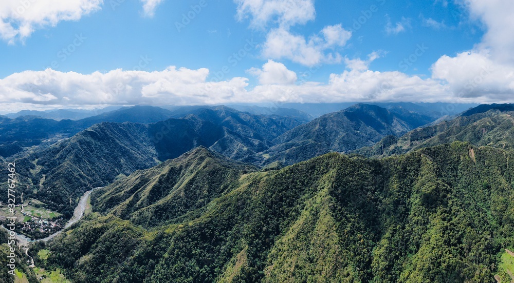 Drone Aerial Panorama of mountains and rice fields and blue sky / agricultural landscape asia