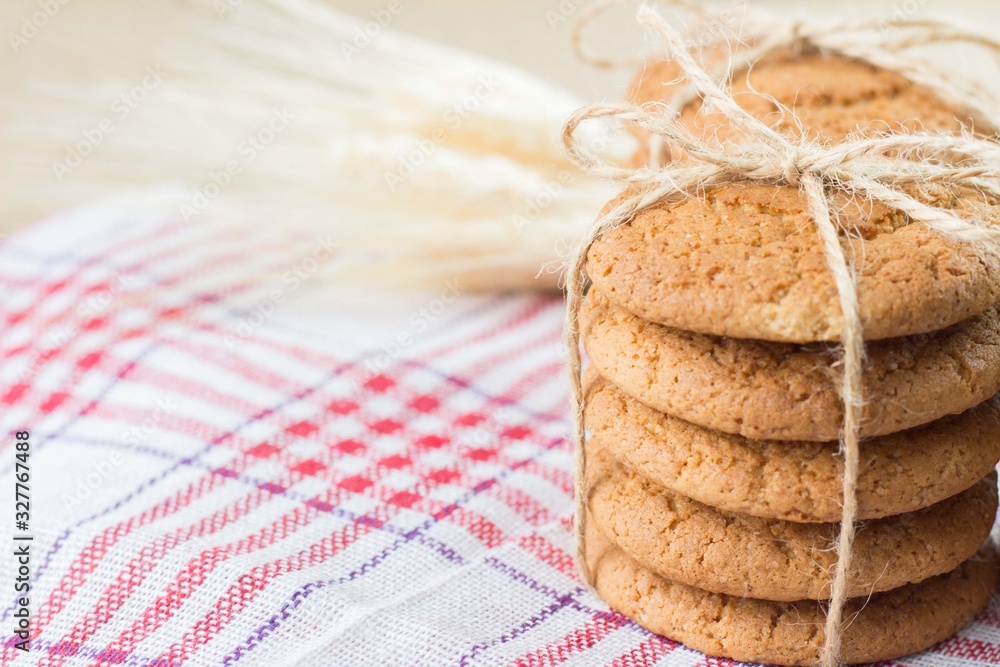 oatmeal cookies in a paper bag on burlap. Concept photo - vegetable food, eco-friendly packaging and natural background