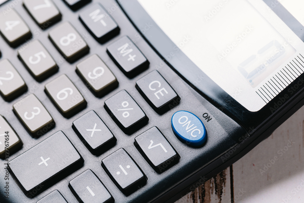 Modern calculator, Business and Finance accounting concept on wooden table Modern calculator, Business and Finance accounting concept on wooden table