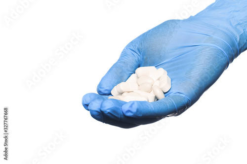 Doctor hand in sterile gloves holding  pill isolated on white background  close up view  - Image