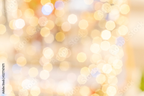 Gold bokeh background. Abstract glitter festive blur lights. Soft yellow christmas backdrop.