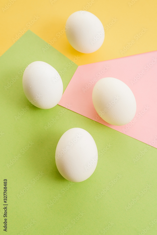 White eggs on a colorful background. minimal fashion concept , flat lay , top view