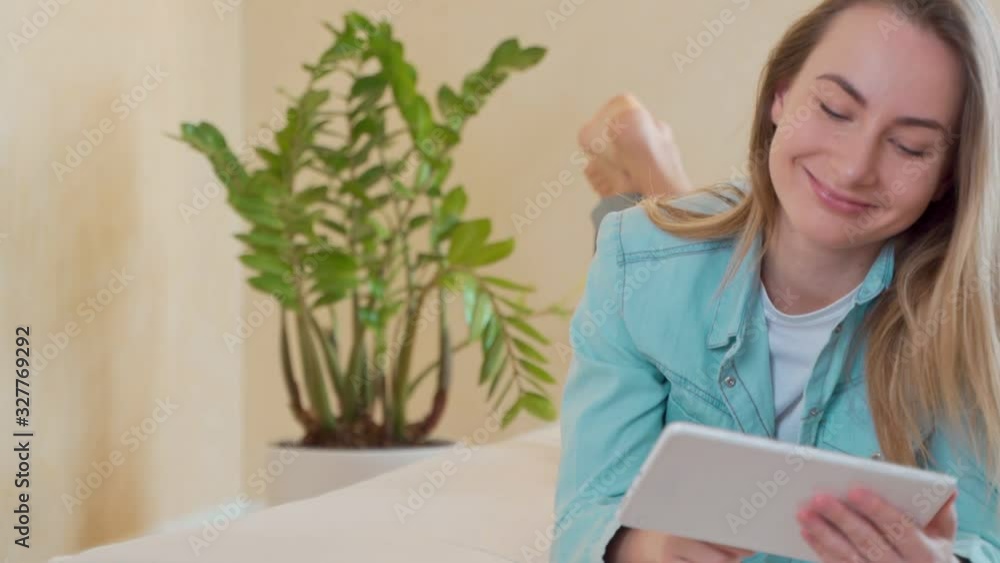 Beautiful Young Woman Using Digital Tablet in Bed Beautiful Young Woman Using Digital Tablet in Bed