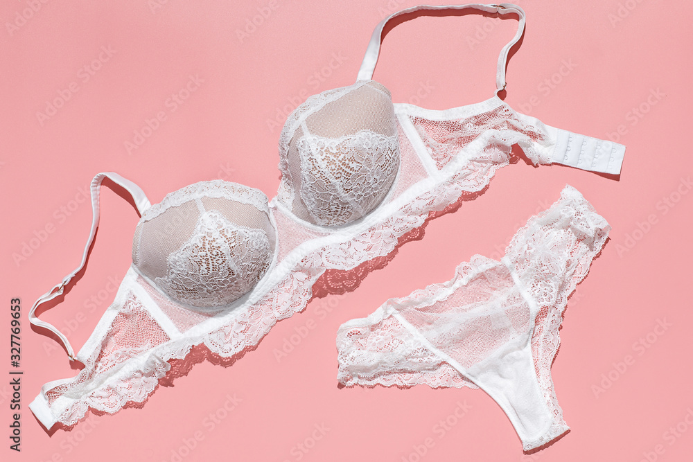 Sexy white lace bra and panties on pink background. Stylish lingerie flat  lay. Underwear fashion concept. Stock Photo