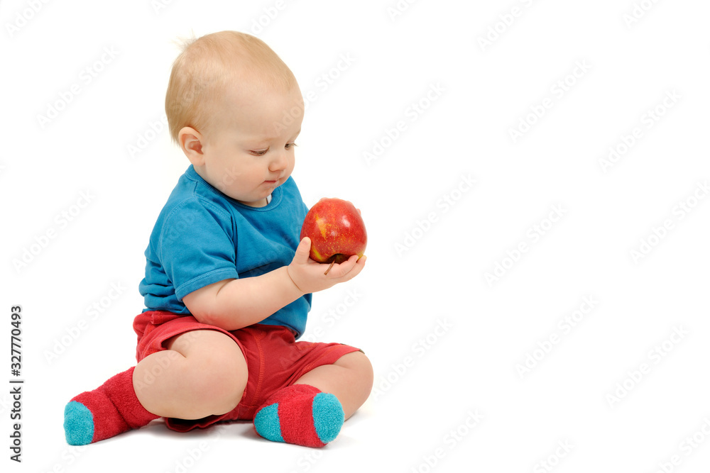 Baby boy with an apple on white background Baby boy with an apple on white background