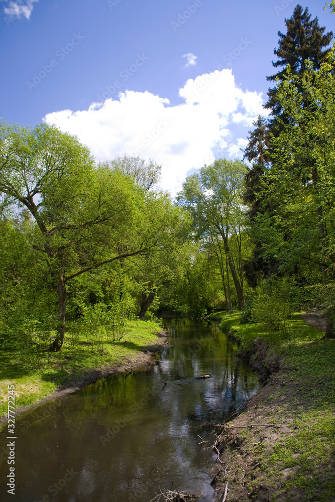 calm picturesque spring landscape with green trees in the park in Żelazowa Wola in Poland calm picturesque spring landscape with green trees in the park in Żelazowa Wola in Poland