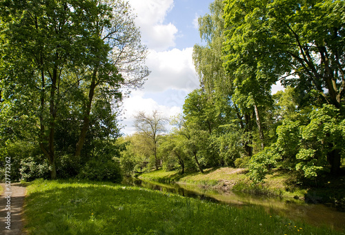 calm picturesque spring landscape with green trees in the park in Żelazowa Wola in Poland © Joanna Redesiuk