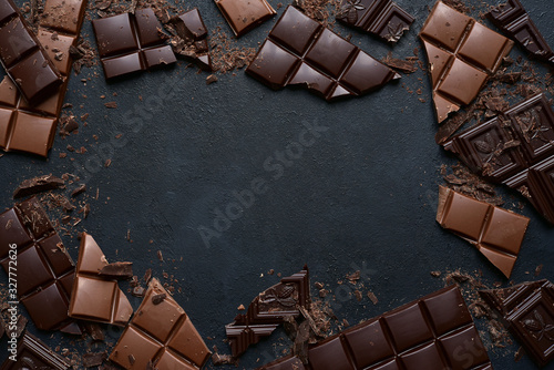 Slices of dark and milk chocolate. Top view with copy space. photo