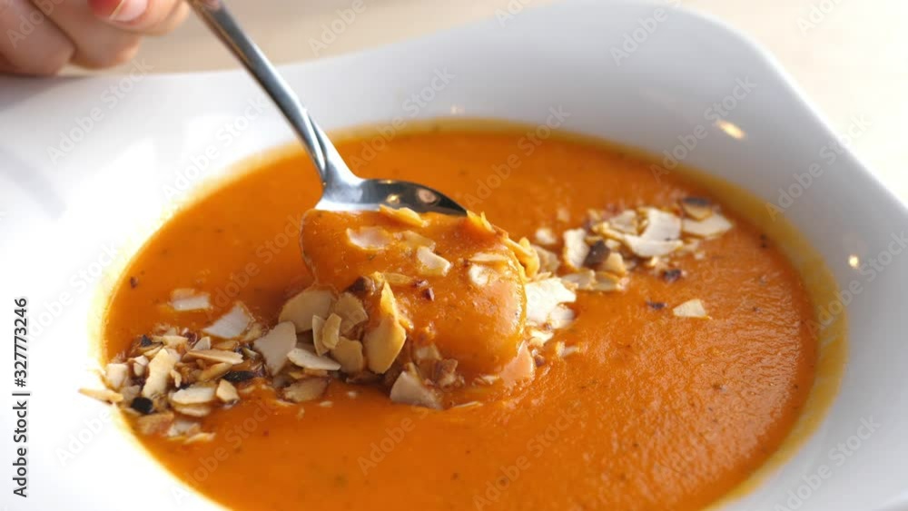 Eating Tomato Cream Soup With A Spoon. Closeup. Eating Tomato Cream Soup With A Spoon. Closeup.