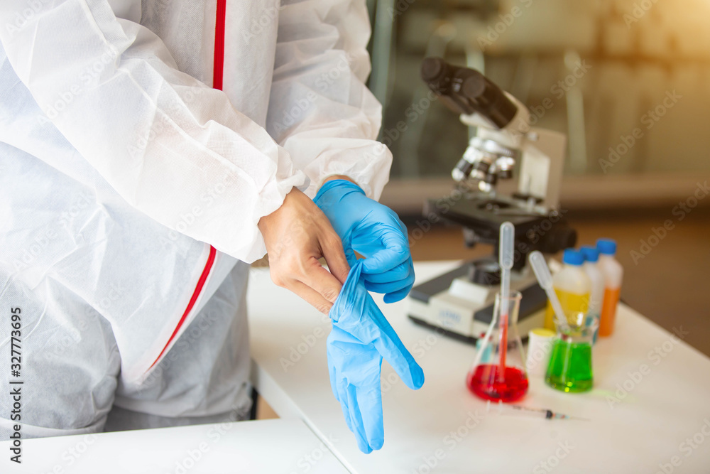The doctor is testing a sample of biological tubes contaminated by Corona-virus Covid 19 and searching for a vaccine against the virus. In the laboratory and film samples of infected lung The doctor is testing a sample of biological tubes contaminated by Corona-virus Covid 19 and searching for a vaccine against the virus. In the laboratory and film samples of infected lung