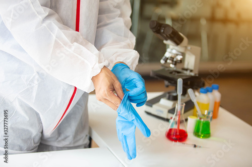 The doctor is testing a sample of biological tubes contaminated by Corona-virus Covid 19 and searching for a vaccine against the virus. In the laboratory and film samples of infected lung