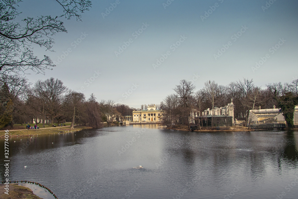  autumn landscape of the Łazienki Królewskie park in Warsaw in Poland with a palace on the water in the background